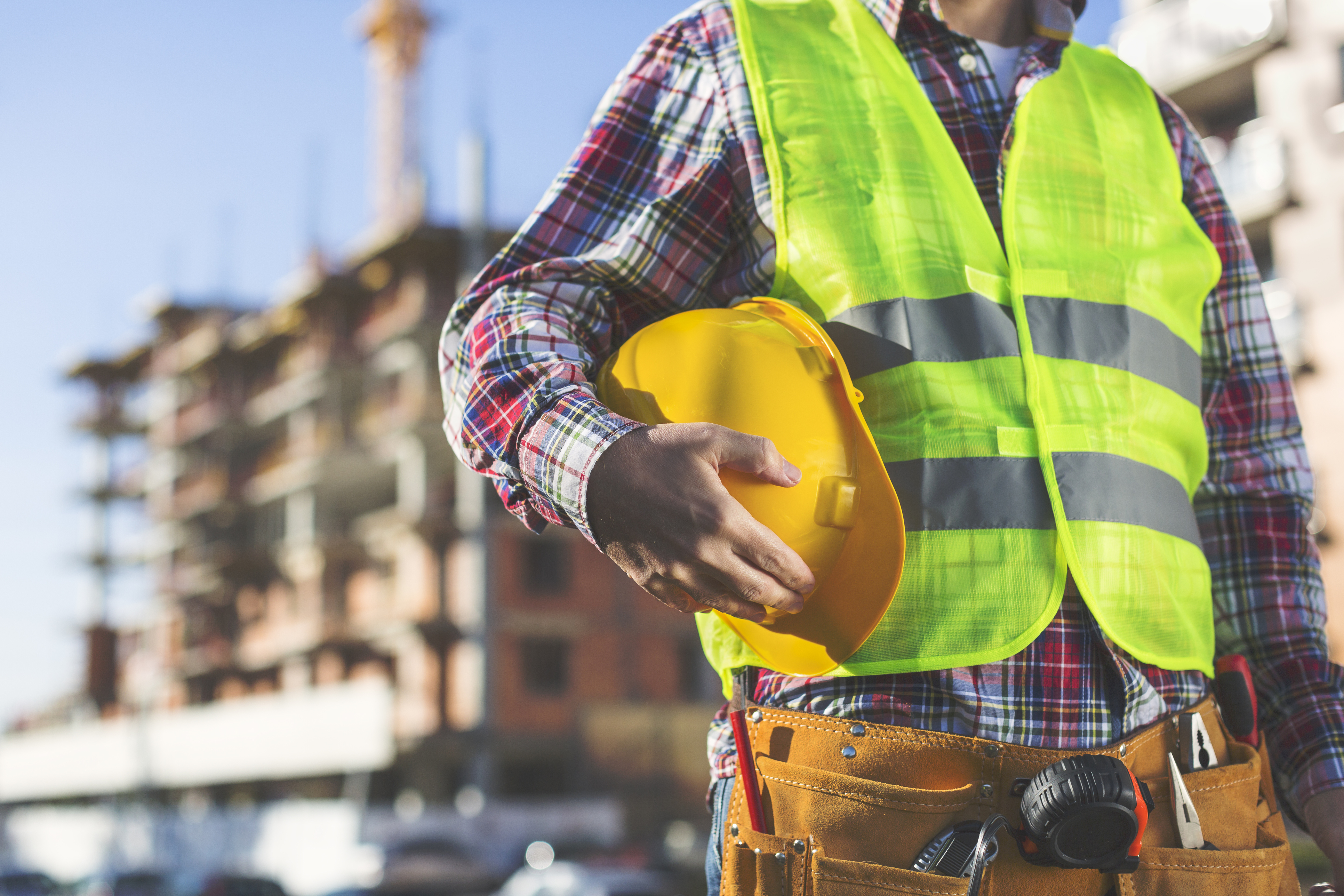 Construction Worker  holding helmet